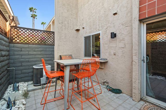 a backyard of a house with table and chairs