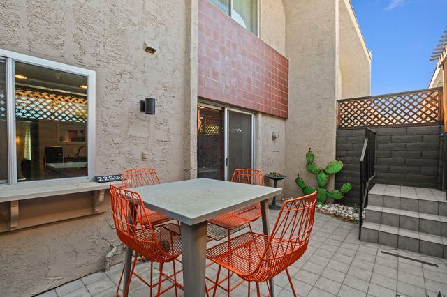 a outdoor space with a table and chairs