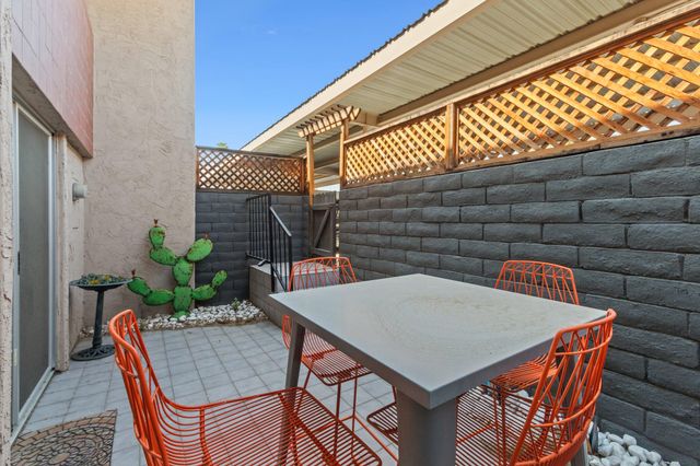 a backyard of a house with table and chairs