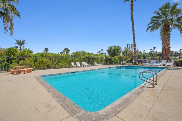 a view of swimming pool with outdoor seating and plants