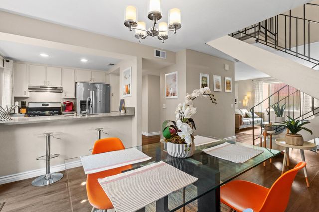 a living room with stainless steel appliances kitchen island granite countertop furniture and a dining table