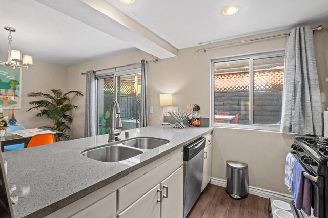 a kitchen with sink and view of living room