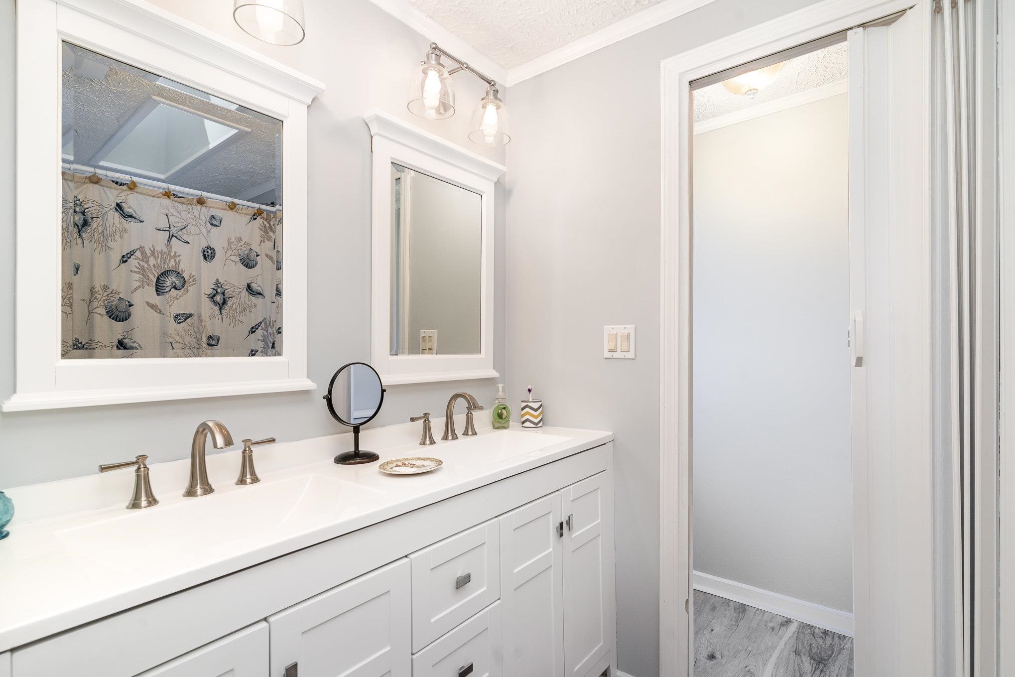 706 Oliver Drive Murrells Inlet, SC 29576 - Photo 13 of 29 Bathroom featuring a shower with shower curtain, double vanity, a textured ceiling, and crown molding