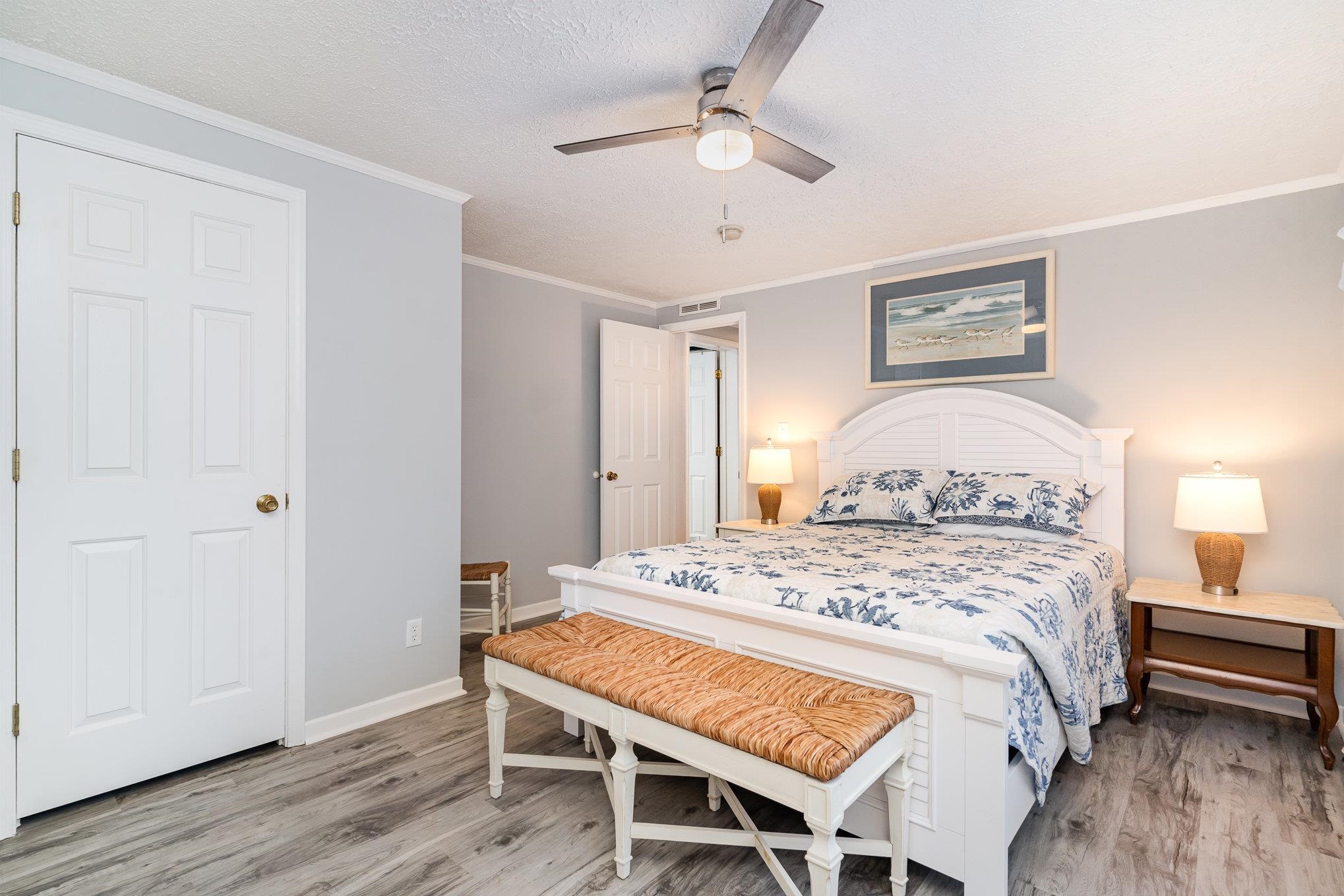 706 Oliver Drive Murrells Inlet, SC 29576 - Photo 14 of 29 Bedroom featuring crown molding, light wood-type flooring, a textured ceiling, and a ceiling fan