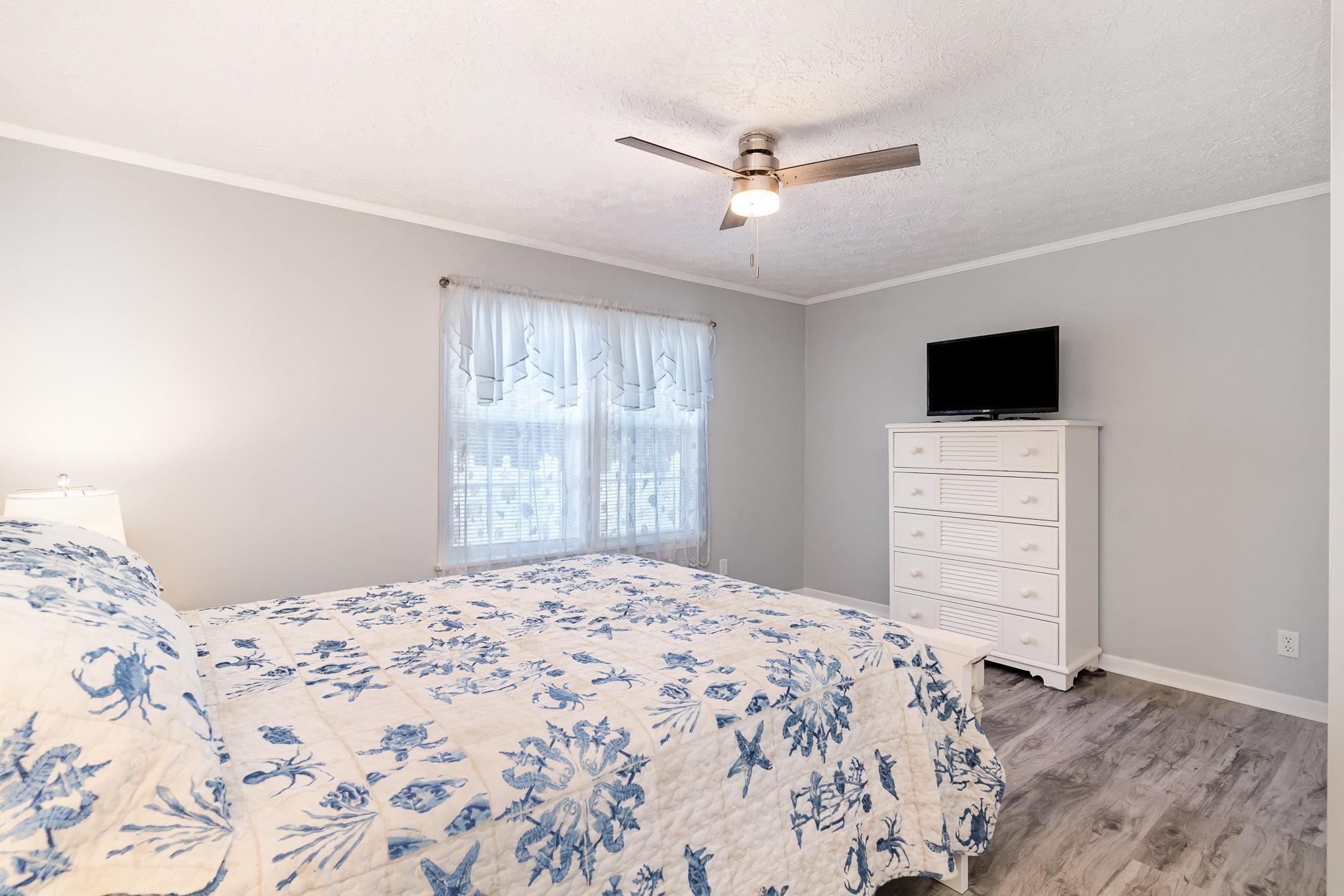 706 Oliver Drive Murrells Inlet, SC 29576 - Photo 15 of 29 Bedroom featuring crown molding, a ceiling fan, a textured ceiling, and light wood-style floors
