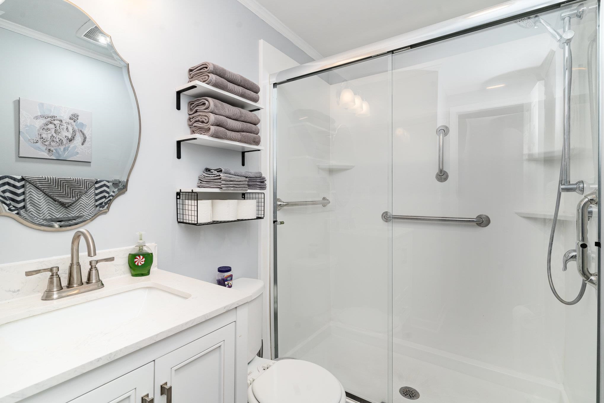 706 Oliver Drive Murrells Inlet, SC 29576 - Photo 18 of 29 Bathroom featuring vanity, crown molding, and a stall shower