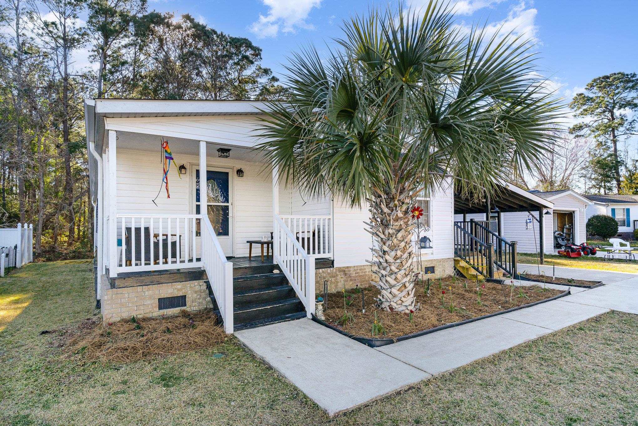 706 Oliver Drive Murrells Inlet, SC 29576 - Photo 2 of 29 Bungalow-style home with covered porch, a front yard, and crawl space
