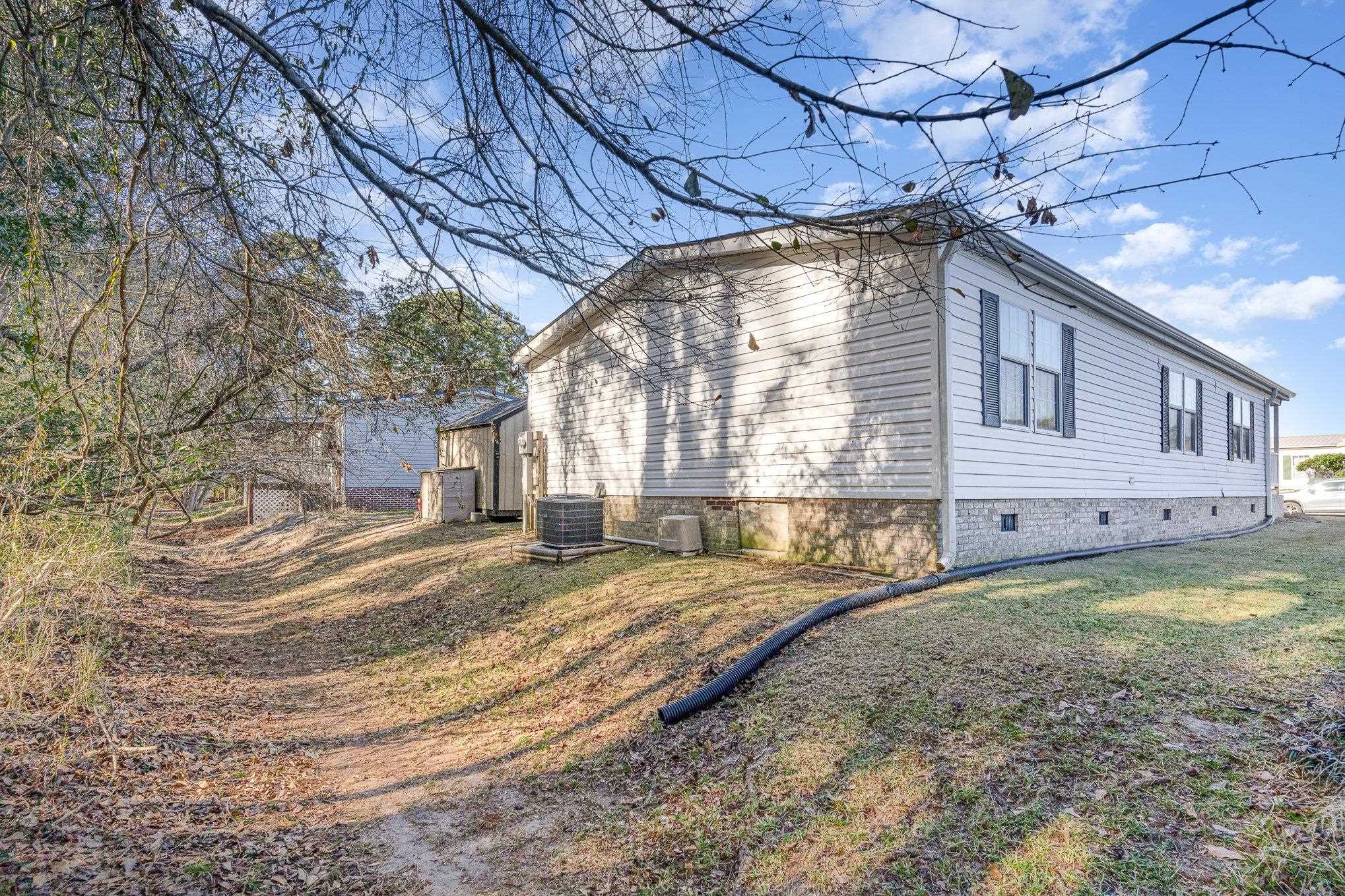 706 Oliver Drive Murrells Inlet, SC 29576 - Photo 26 of 29 View of side of home with crawl space and a lawn