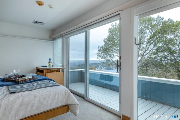 a spacious bedroom with a bed and a window