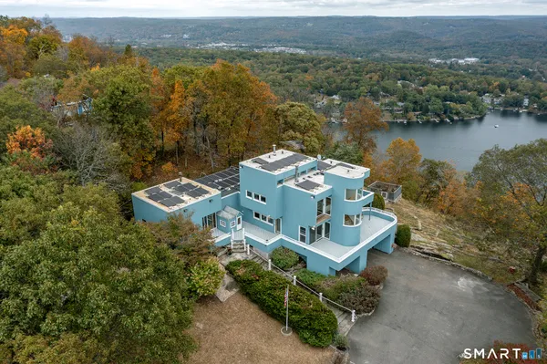 an aerial view of a house with a lake view