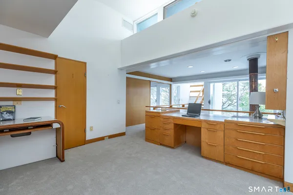 a room with walk in closet and bedroom view