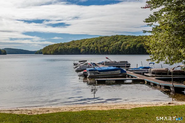 a view of a lake with lawn chairs