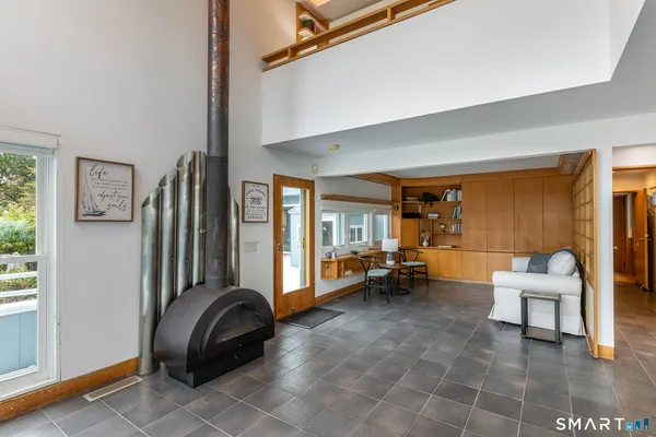a living room with furniture a rug and a large window