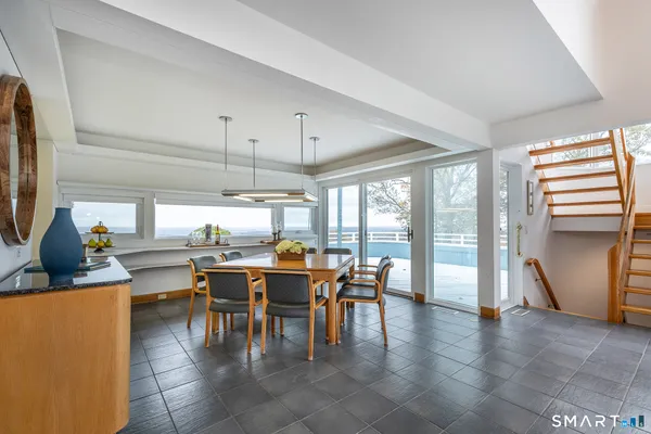 a view of a dining room with furniture window and outside view