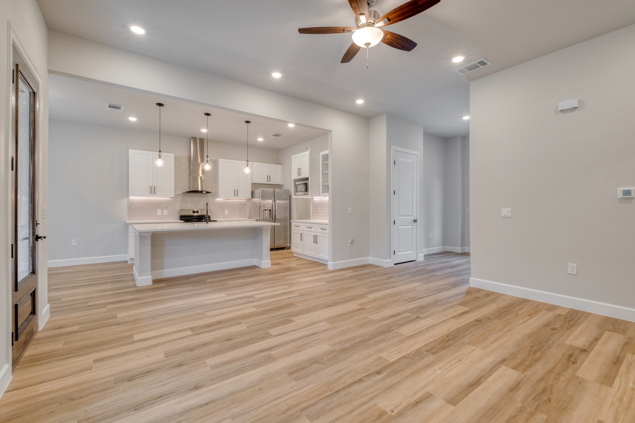 116 Pine Point Cove Elgin, TX 78621 - Photo 8 of 27 Open-concept living area featuring wood-finish flooring and recessed lighting