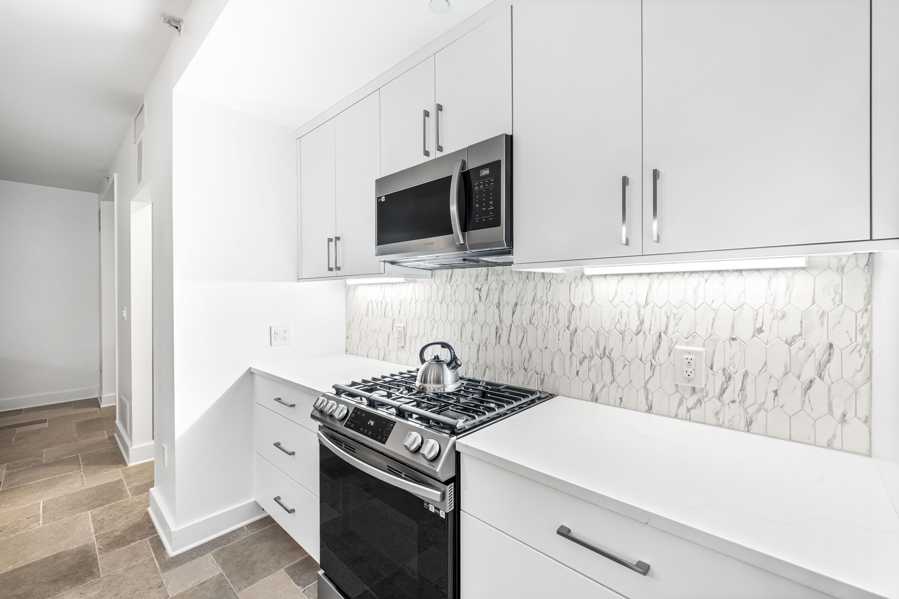 136 Georgetown Avenue, Unit 3B3 Inlet Beach, FL 32461 - Photo 12 of 68 a kitchen with stainless steel appliances white cabinets and a stove top oven