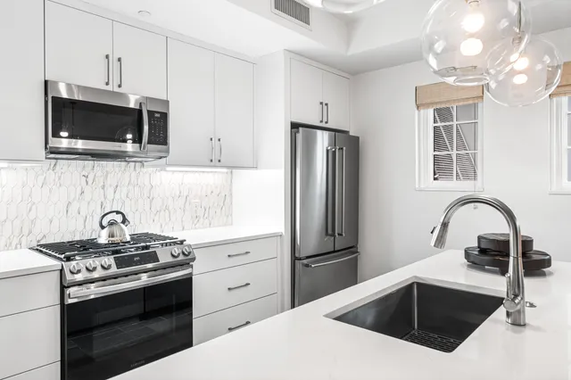 a hallway with a couch and a window