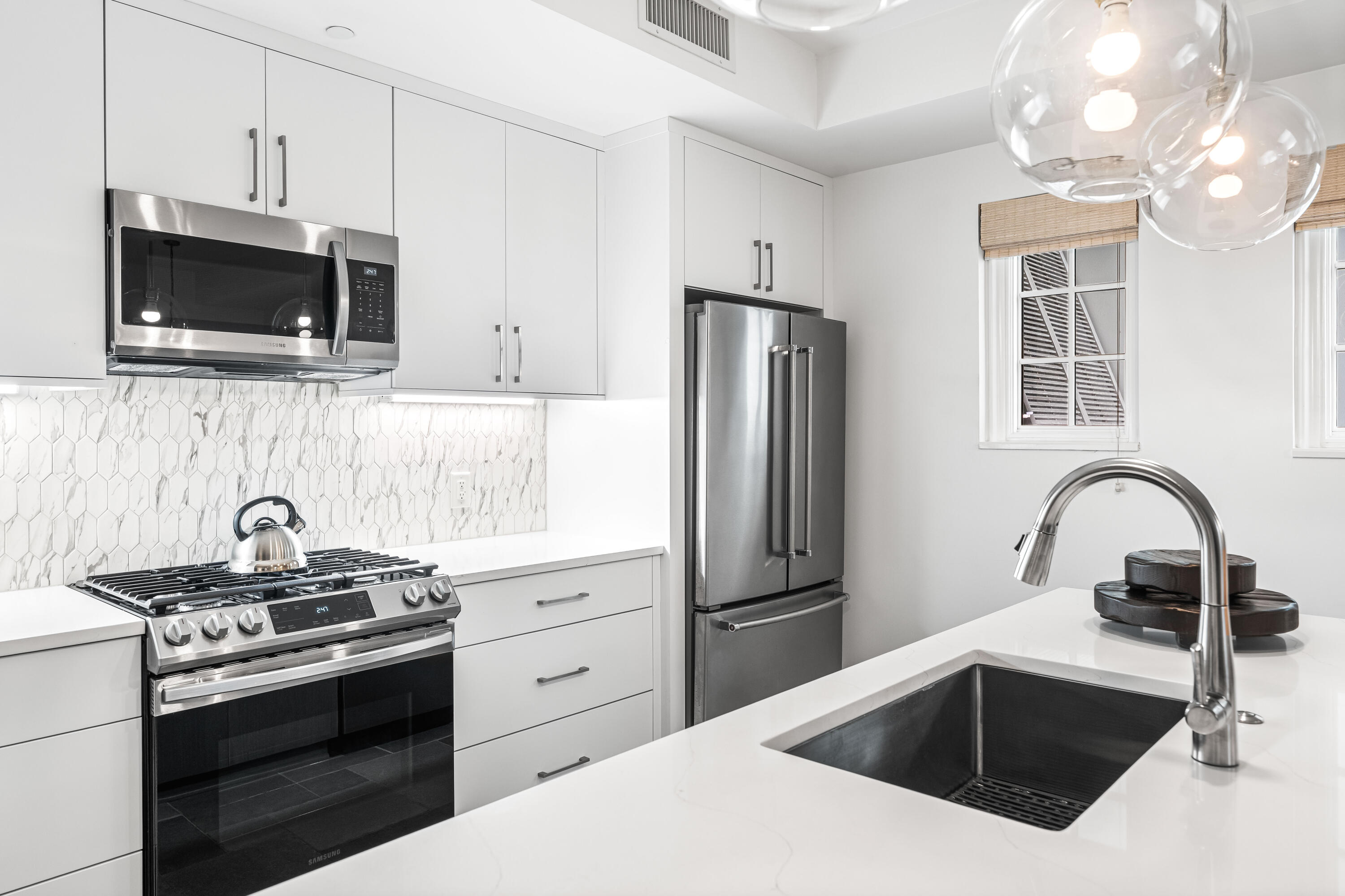 136 Georgetown Avenue, Unit 3B3 Inlet Beach, FL 32461 - Photo 13 of 68 a kitchen with stainless steel appliances a stove microwave and sink