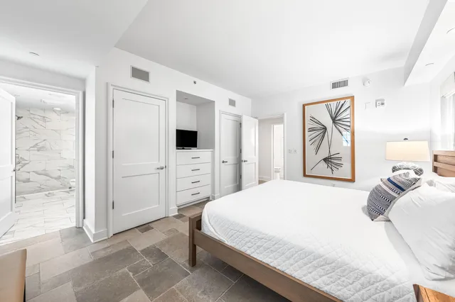 a bedroom with a bed and a desk