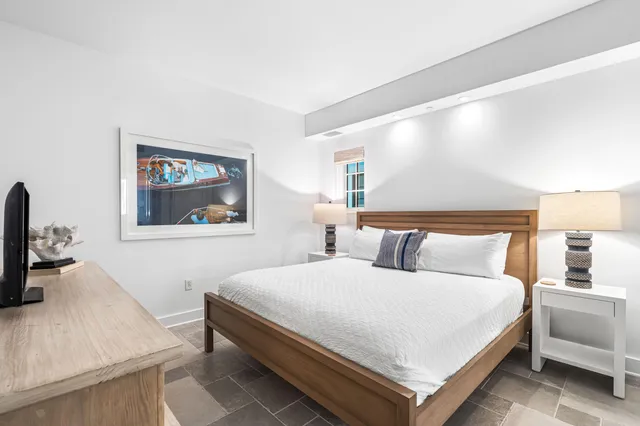 a bathroom with a granite countertop sink and a bathtub