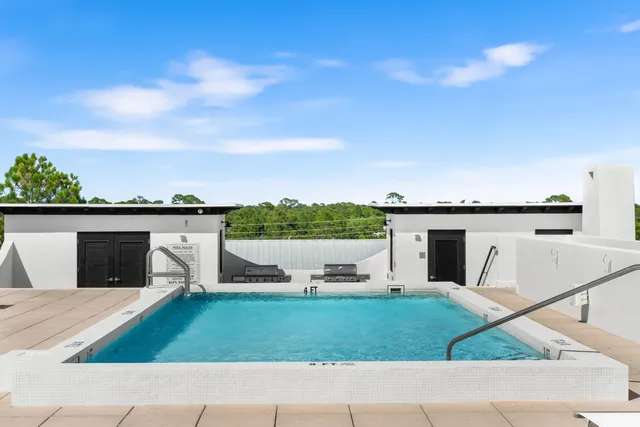 a view of swimming pool with outdoor seating and kitchen view