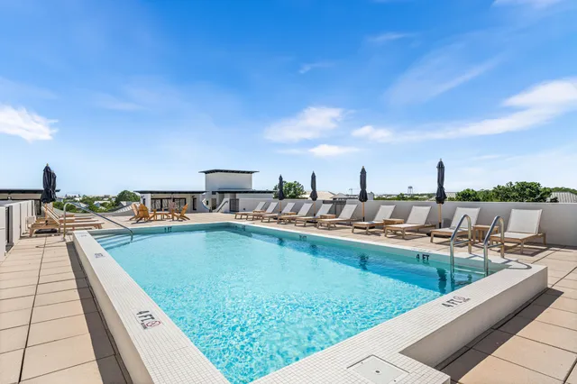 a view of a house with swimming pool and sitting area