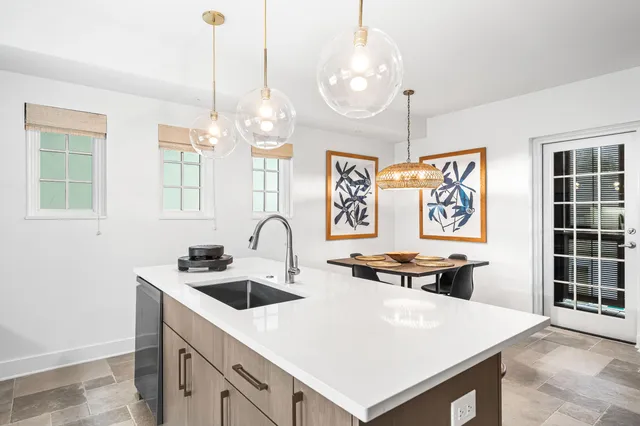 a very nice looking dining room with kitchen island furniture and a chandelier