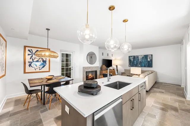 a kitchen with stainless steel appliances a dining table and chairs
