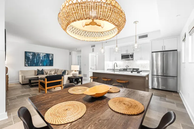a kitchen with stainless steel appliances white cabinets and a stove top oven