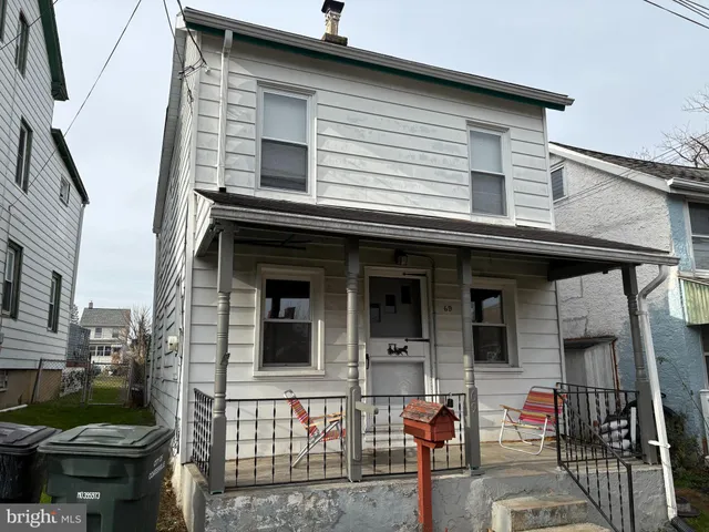 a front view of a house with outdoor seating