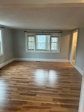 19 Water Street, Unit 1 Milford, MA 01757 - Photo 7 of 15 a view of empty room with wooden floor and fan