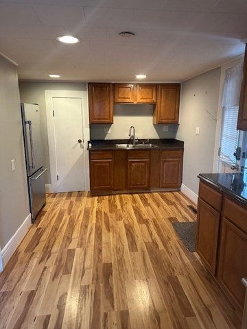 19 Water Street, Unit 1 Milford, MA 01757 - Photo 8 of 15 a kitchen with stainless steel appliances granite countertop a refrigerator and a sink