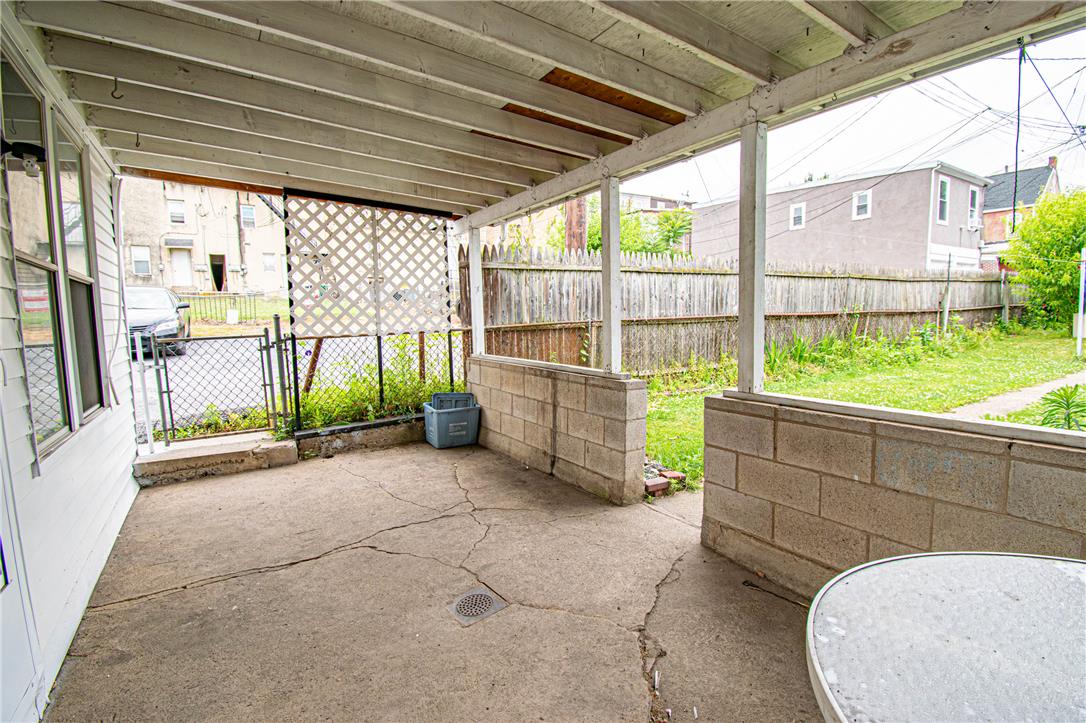 27 West Allen Street Allentown, PA 18102 - Photo 23 of 26 A quaint covered patio, ideal for outdoor relaxation, features a concrete floor and opens to a fenced yard.
