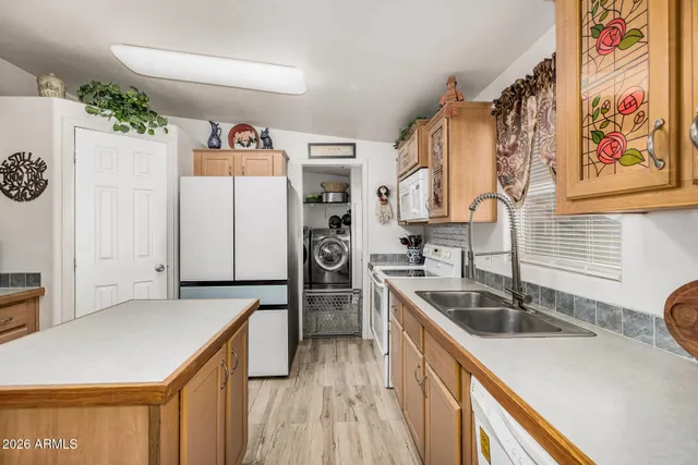 a kitchen that has a sink a refrigerator and a sink