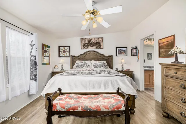 a bed sitting in a bedroom and a chandelier