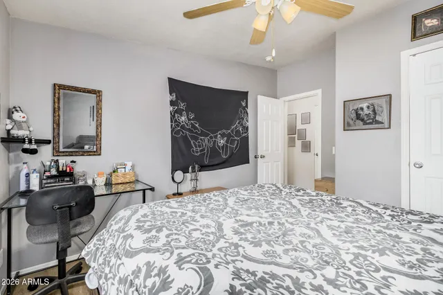 a bedroom with a bed and a chandelier