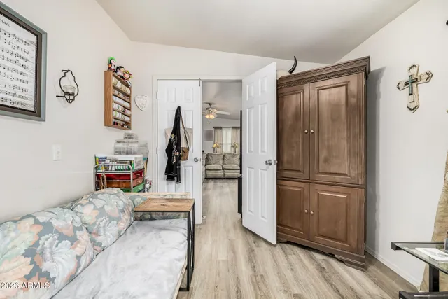 a bed room with a bed and a refrigerator