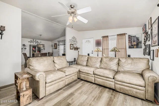 a living room with furniture a ceiling fan and a rug