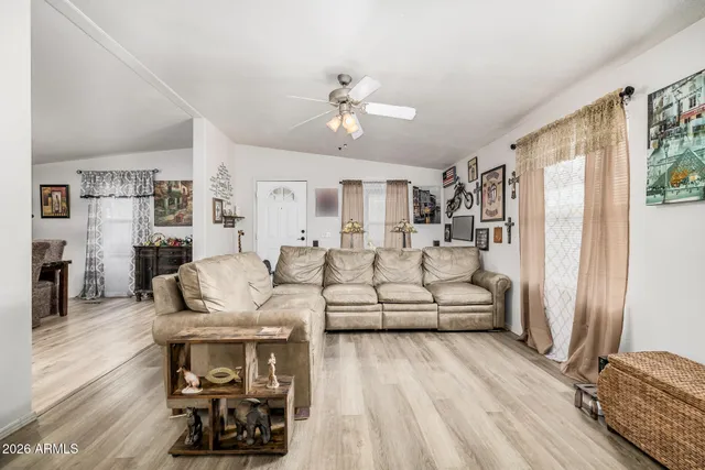 a living room with furniture and a wooden floor