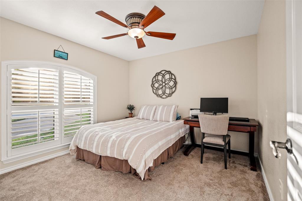 400 Hunters Ridge Circle Coppell, TX 75019 - Photo 20 of 35 a bedroom with a bed and a window