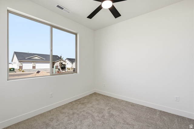 4978 North 75 East Enoch, UT 84721 - Photo 28 of 60 Unfurnished room with ceiling fan and light colored carpet