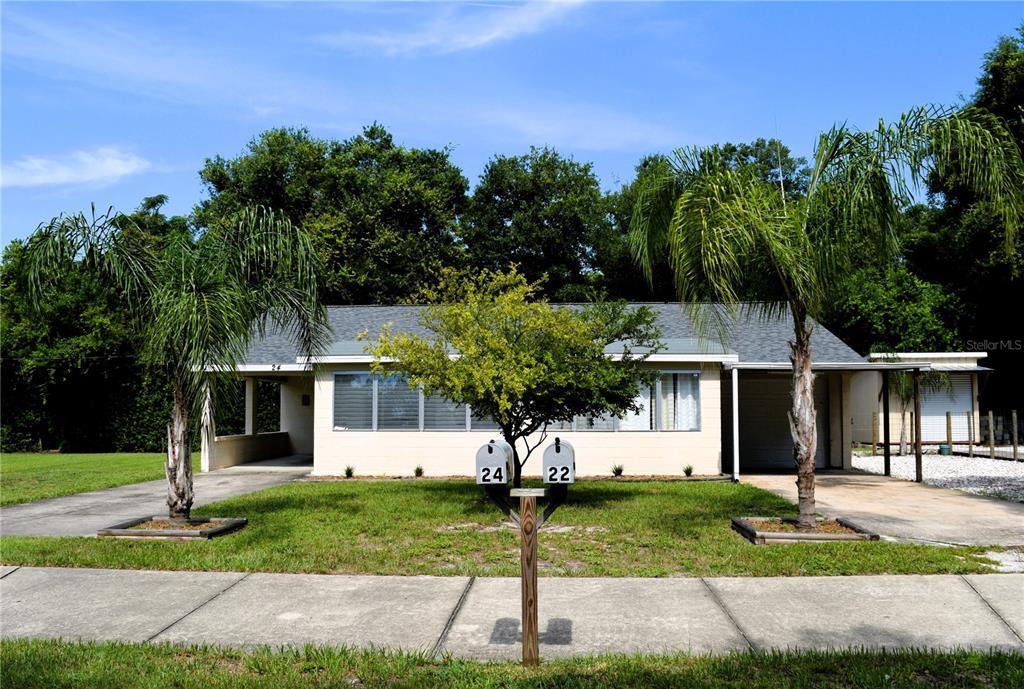 22 Amigos Road DeBary, FL 32713 - Photo 1 of 1 a front view of a house with a yard and tree