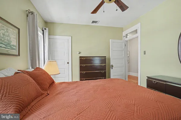 a view of a bedroom with a window and brick walls