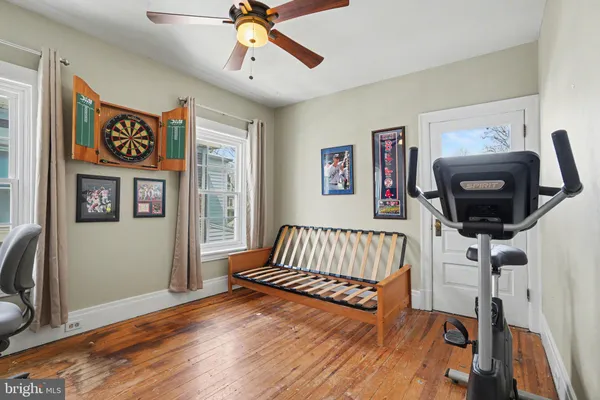 a backyard of a house with lots of plants and tree