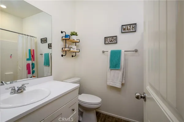 a bathroom with a sink mirror and toilet