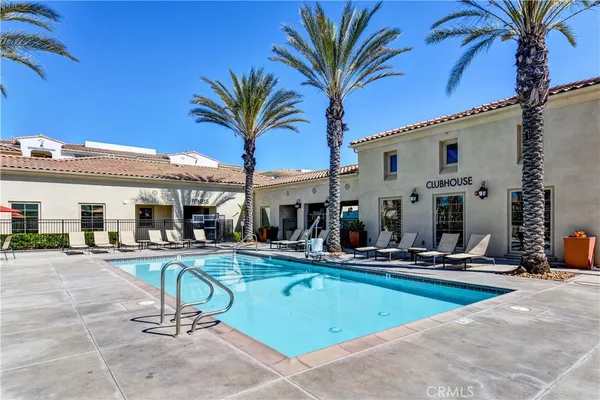 a view of a swimming pool with chairs