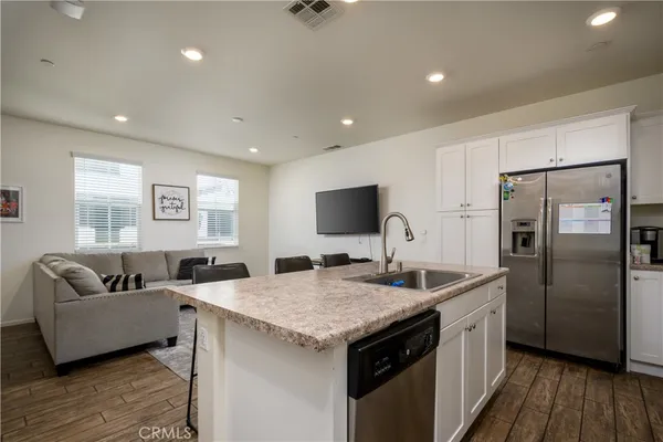 a kitchen with sink refrigerator and microwave