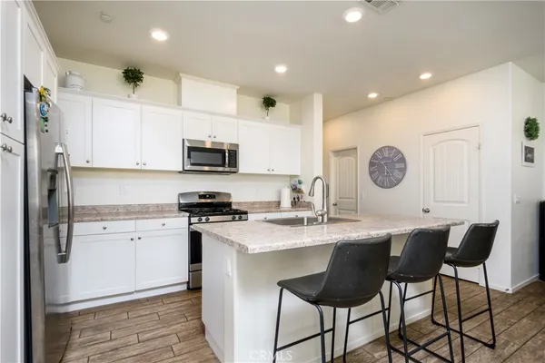 a kitchen with a sink stainless steel appliances and cabinets