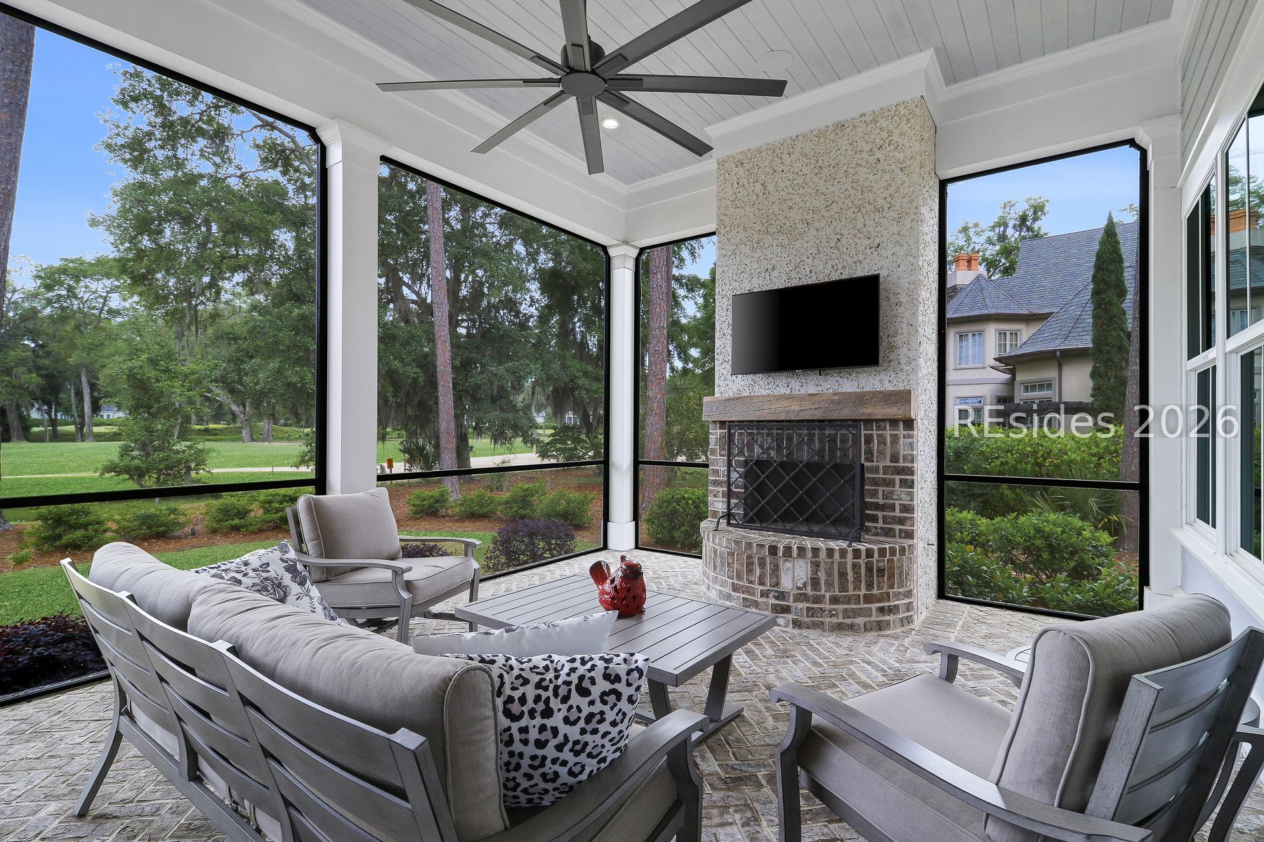 18 Ballybunion Way Bluffton, SC 29910 - Photo 54 of 64 Screened porch with outdoor fireplace