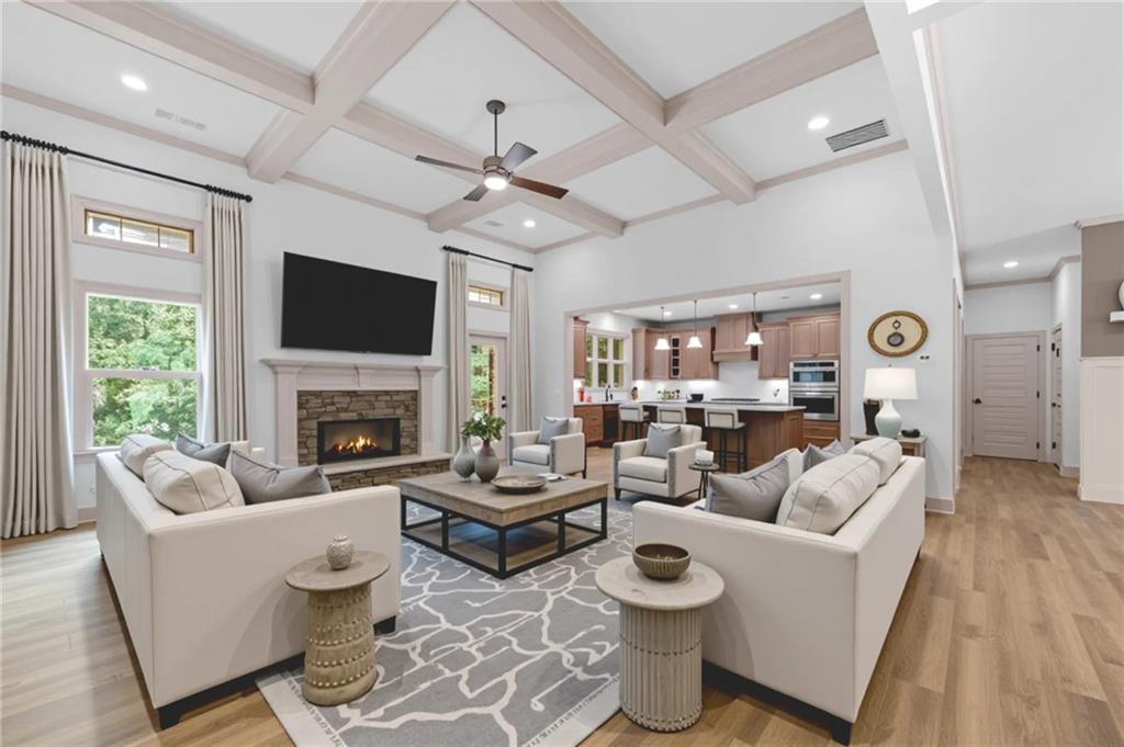 4786 Conns Creek Road Ball Ground, GA 30107 - Photo 1 of 1 a living room with couches a fireplace and a flat screen tv